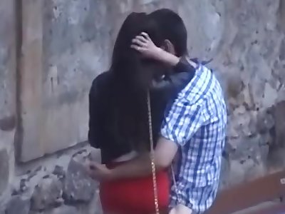 Spanish couple kissing on the street